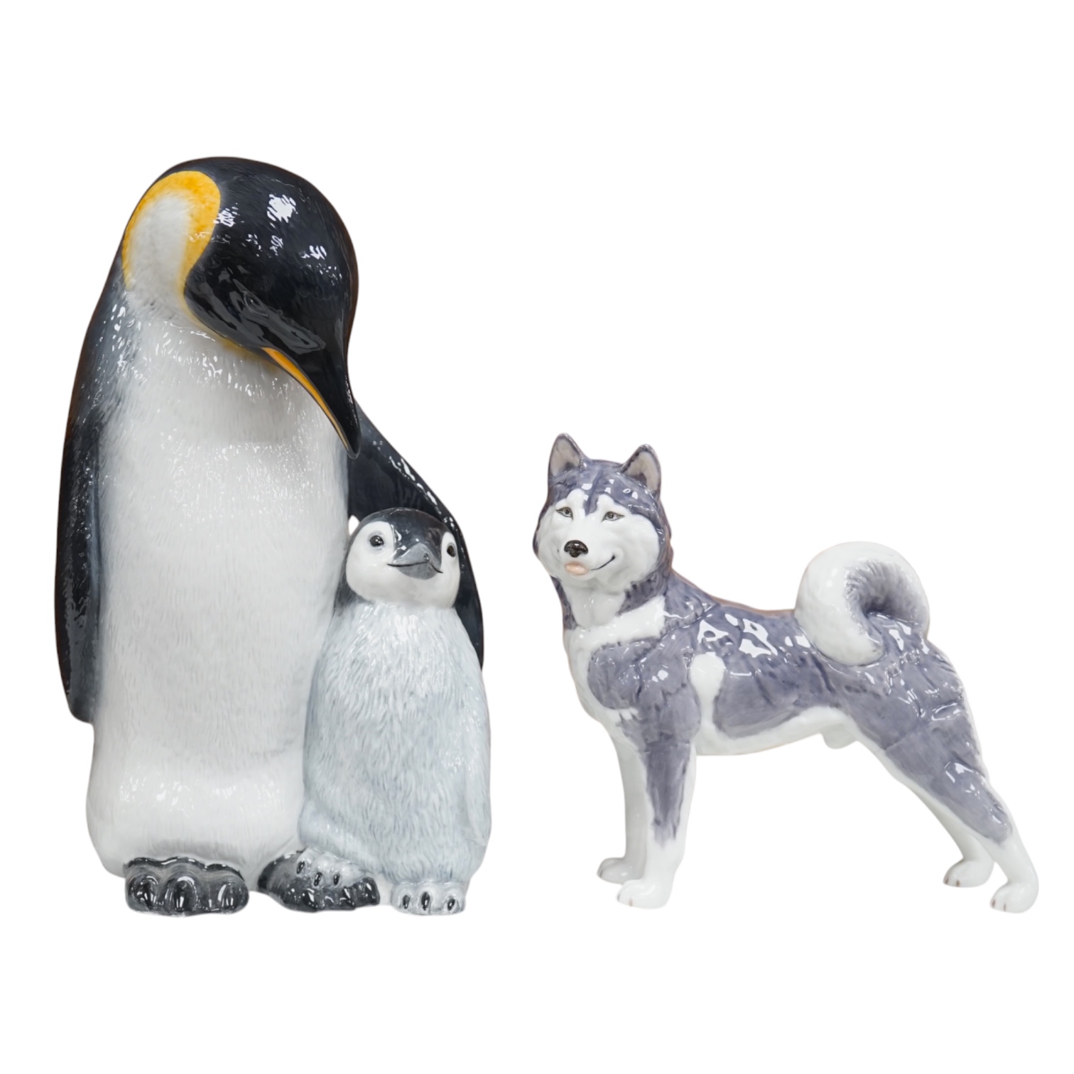 A Royal Copenhagen penguin group and a similar husky figure, 088 and 038, tallest 22cm. Condition - good